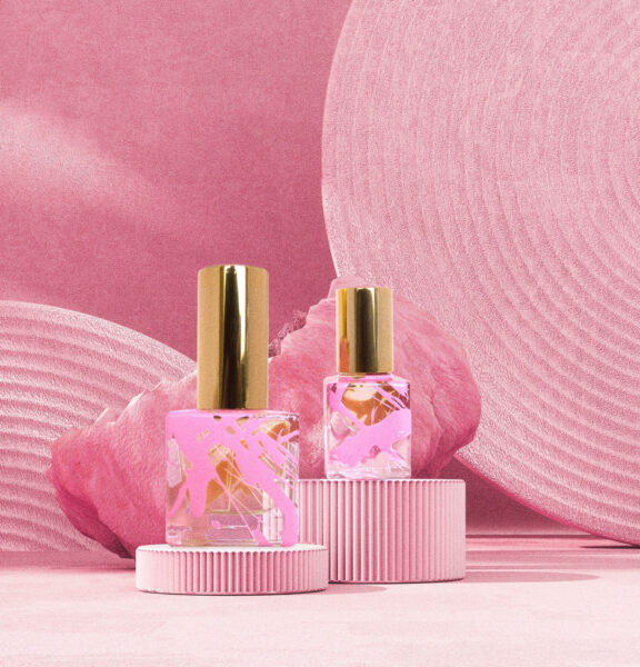 Dripping Nectar Concoction 15 eau de parfum 15ml and 4ml square bottles with gold cap on pink abstract background pink podium and pink wavy striped background.